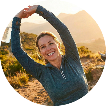 Woman stretching at sunrise