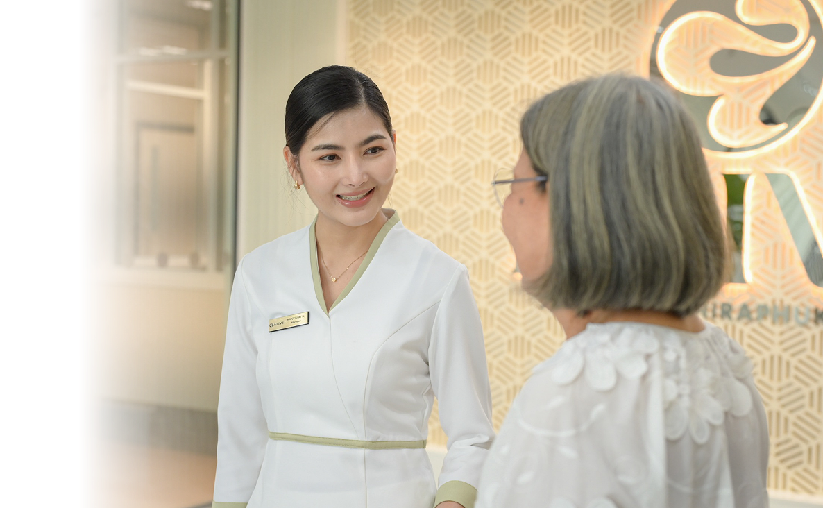Two ALIVE clinicians in white coats smiling at one another